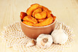 Appetizing village potatoes in bowl on wooden table close-up