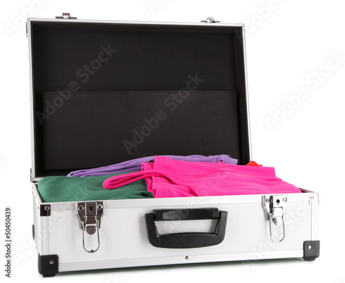 Photo: Open silver suitcase with clothing isolated on white Open silver suitcase with clothing isolated on white