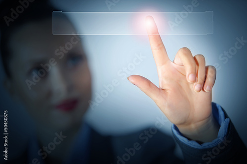 Photo: Business woman touching display Business woman touching display
