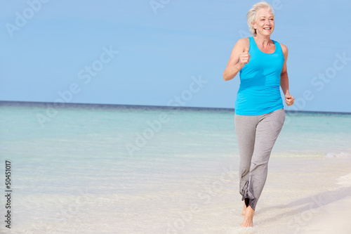 Photo: Senior Woman Running On Beautiful Beach Senior Woman Running On Beautiful Beach