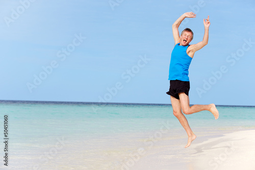 Photo: Senior Man Jumping On Beautiful Beach Senior Man Jumping On Beautiful Beach