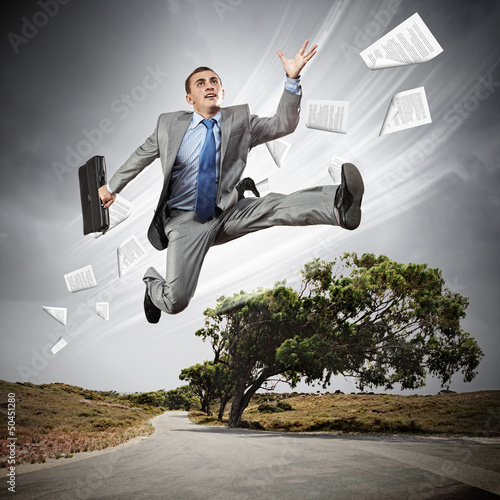 Photo: Businessman running on the road Businessman running on the road