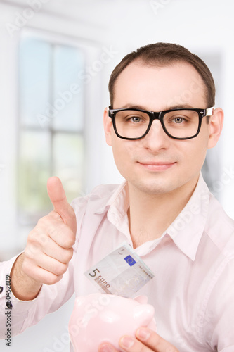 Photo: businessman with piggy bank and money businessman with piggy bank and money
