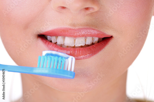 Photo: Beautiful young woman with toothbrush close-up Beautiful young woman with toothbrush close-up