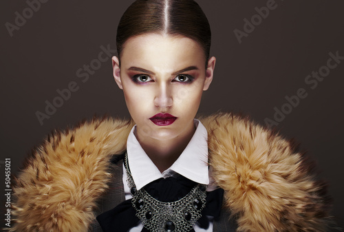 Photo: Beautiful Fashionable Strict Fashion Model in Fur Coat. Luxury Beautiful Fashionable Strict Fashion Model in Fur Coat. Luxury