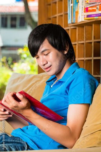 Photo: Asian student reading book or textbook learning Asian student reading book or textbook learning