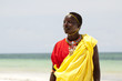 Portrait of young Massai man on bright beach, with narrow focus