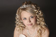 Foto: Woman dressed as a bride on a gray. Woman dressed as a bride on a gray.