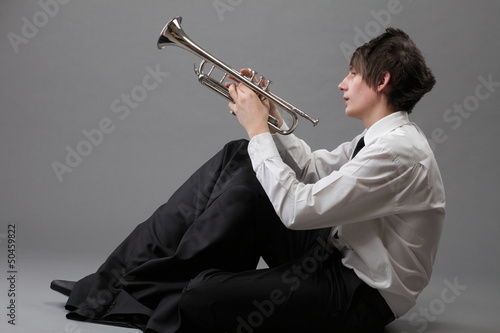 Photo: Portrait of a young man and his Trumpet music lover Portrait of a young man and his Trumpet music lover