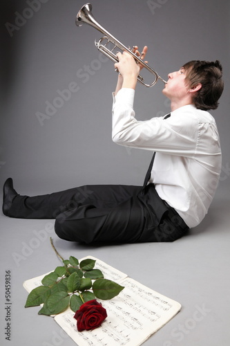 Photo: Portrait of a young man playing love his Trumpet Portrait of a young man playing love his Trumpet