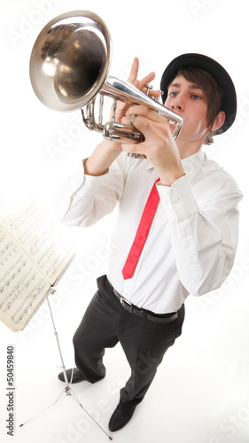 Photo: Portrait of a young man playing his Trumpet music lover Portrait of a young man playing his Trumpet music lover