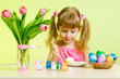 cute kid girl painting Easter eggs