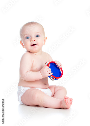 Photo: Baby girl playing musical toy isolated on white Baby girl playing musical toy isolated on white