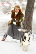 Photo: Happy young woman standing with siberian husky dog Happy young woman standing with siberian husky dog