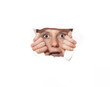 Foto: Young woman looking through torn paper hole Young woman looking through torn paper hole