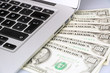 laptop keyboard and money