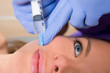 Foto: Anti aging facial mesotherapy syringe on woman face Anti aging facial mesotherapy syringe on woman face