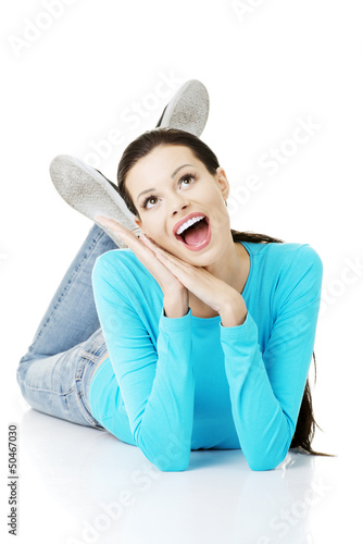 Photo: Young beautiful happy woman lying on floor Young beautiful happy woman lying on floor