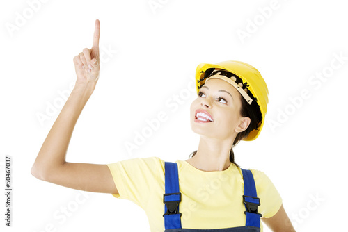 Photo: Female construction worker pointing on copy space Female construction worker pointing on copy space