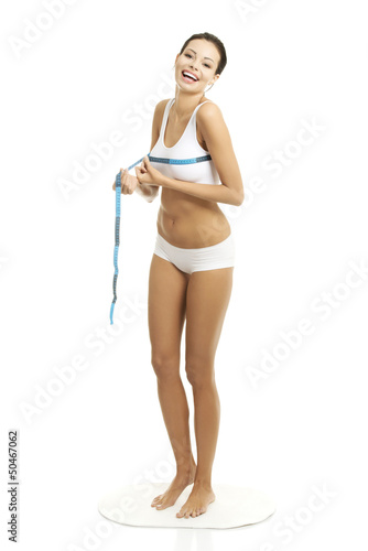 Photo: Pretty smiling woman measuring breast Pretty smiling woman measuring breast