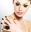 Face of the beautiful woman with black nails and pink lips