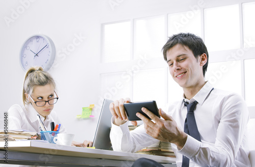 Photo: businessman using smart phone in office businessman using smart phone in office