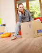 Photo: Young beautiful woman with packages for house moving Young beautiful woman with packages for house moving
