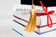 Photo: Graduation cap with book and diploma Graduation cap with book and diploma