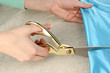 Seamstress cut blue fabric on beige fabric background