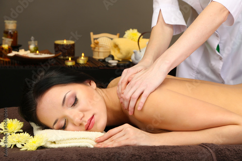 Photo: Beautiful young woman in spa salon getting massage, Beautiful young woman in spa salon getting massage,