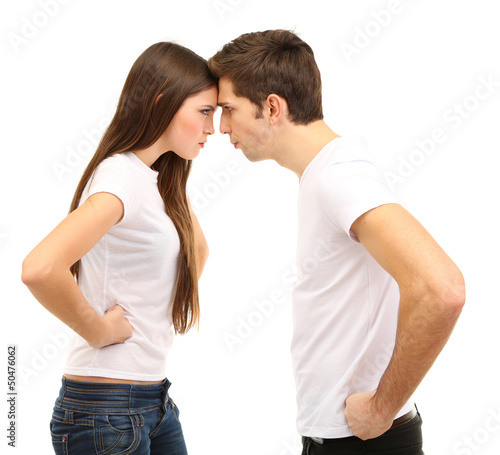 Photo: Young couple quarreling isolated on white Young couple quarreling isolated on white