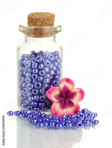 Photo: Little bottle full with colorful beads isolated on white Little bottle full with colorful beads isolated on white