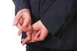 Business man with fingers crossed.