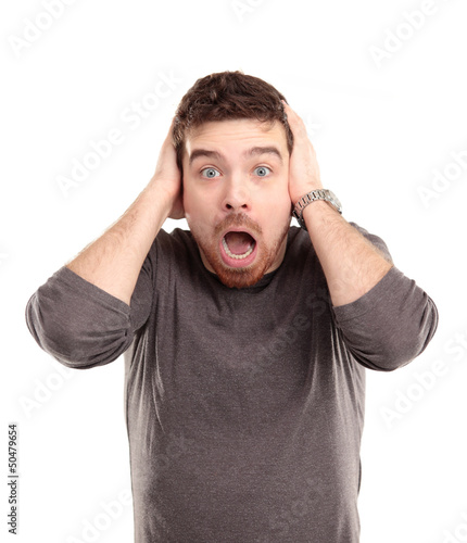 Photo: Portrait of young man with shocked facial expression Portrait of young man with shocked facial expression