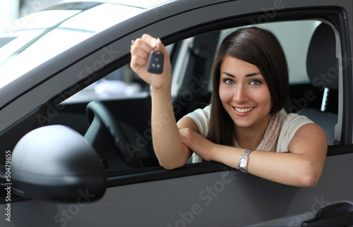 Photo: Happy smiling woman with car key. Driving Happy smiling woman with car key. Driving