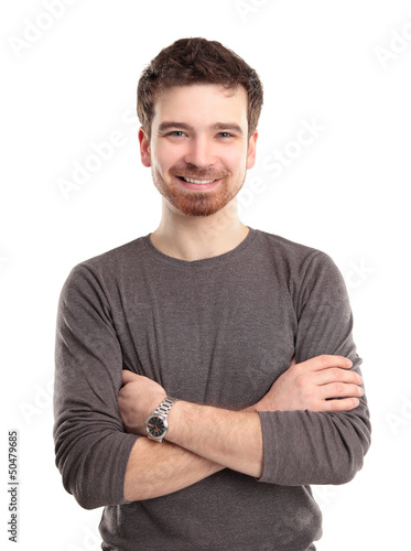 Photo: Casual young man looking at camera with arms crossed Casual young man looking at camera with arms crossed