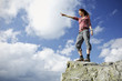 Woman standing on a mountain and gazing in the distance
