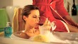 girl drinking a glass of wine in the bath tub