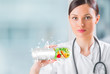 Healthy life concept. Female medical doctor holding vitamins