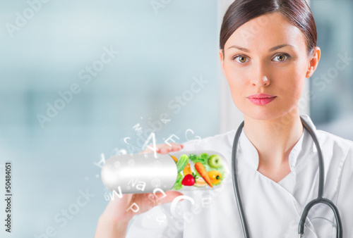 Photo: Healthy life concept. Female medical doctor holding vitamins Healthy life concept. Female medical doctor holding vitamins