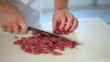 hands cutting fresh meat