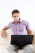 Young man working on computer laptop