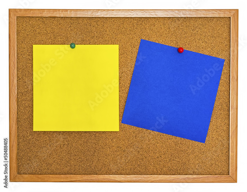 Photo: Yellow and blue note papers pinned on cork board Yellow and blue note papers pinned on cork board