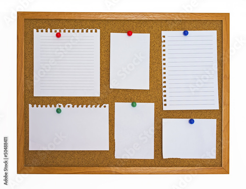 Photo: Multiple type of note papers pinned on cork board Multiple type of note papers pinned on cork board