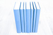 Old blue books on wooden desk