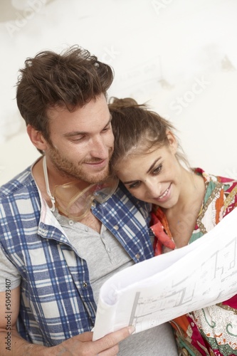 Photo: Happy couple planning a new home Happy couple planning a new home