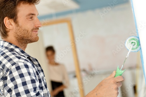 Photo: Happy man painting wall Happy man painting wall