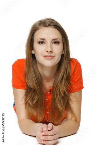 Photo: Young woman lying on the studio floor Young woman lying on the studio floor
