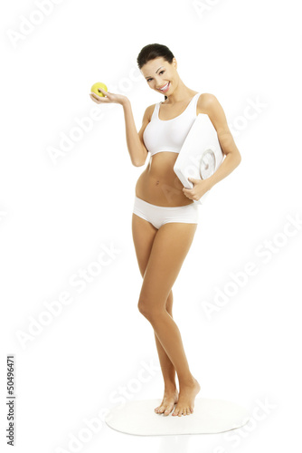 Photo: Attractive fit woman with scale and apple Attractive fit woman with scale and apple