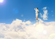 Businesswoman standing on ladder